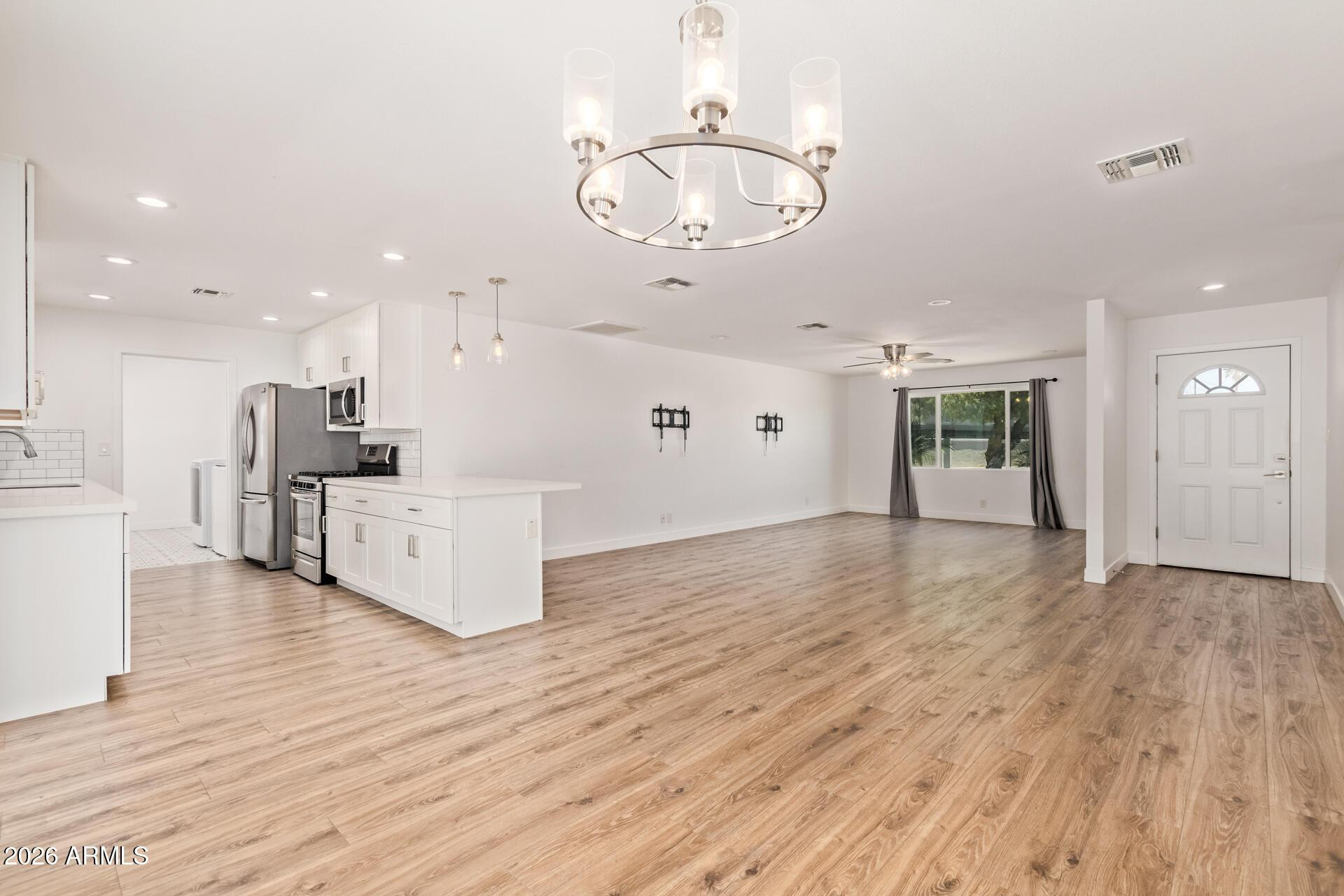 1809 East Concorda Drive Tempe, AZ 85282 - Photo 5 of 23 a view of a kitchen with furniture and wooden floor