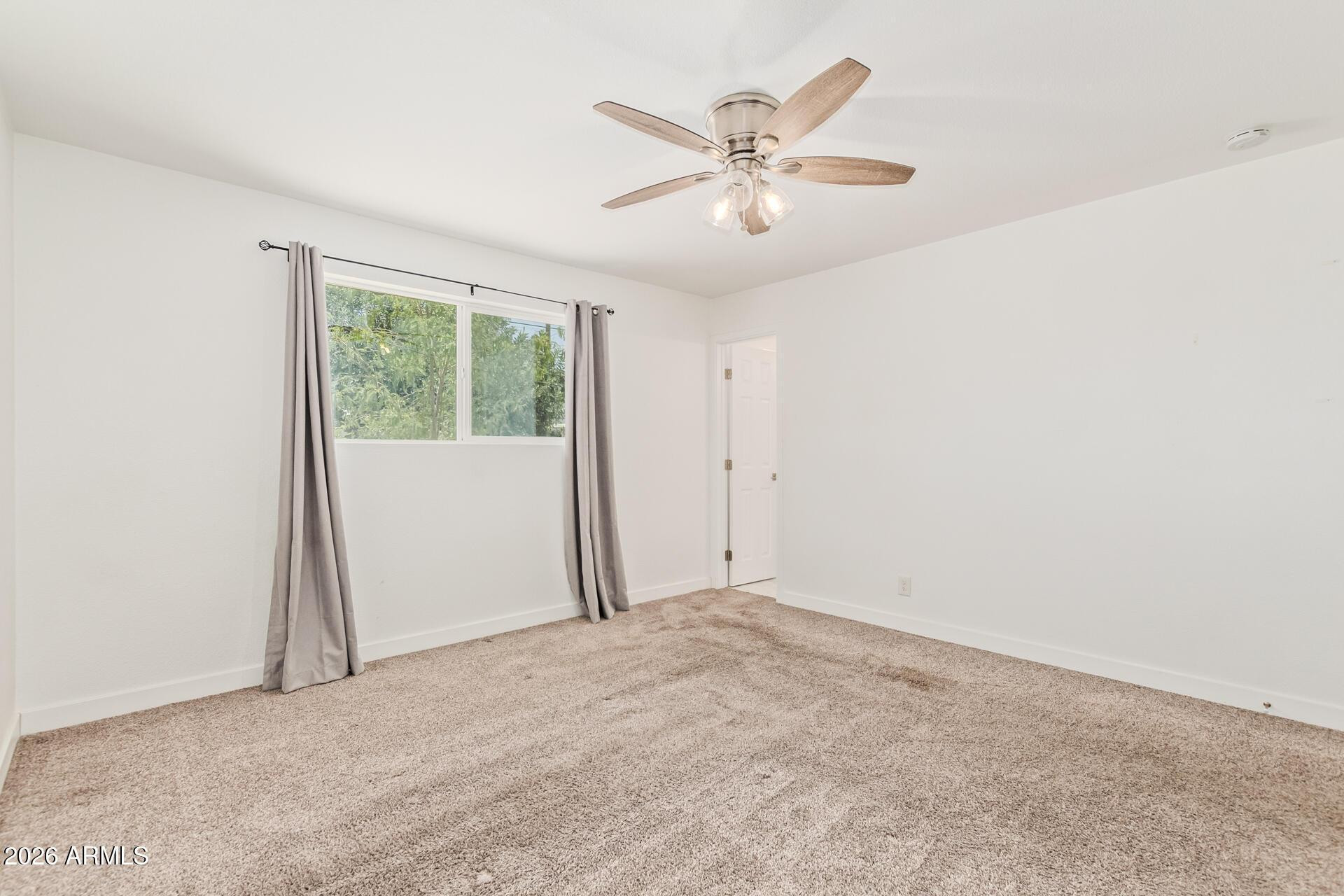 1809 East Concorda Drive Tempe, AZ 85282 - Photo 10 of 23 an empty room with windows and fan