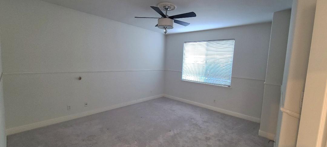 1611 North Monaco Lane Clovis, CA 93619 - Photo 11 of 16 an empty room with a window and a fan