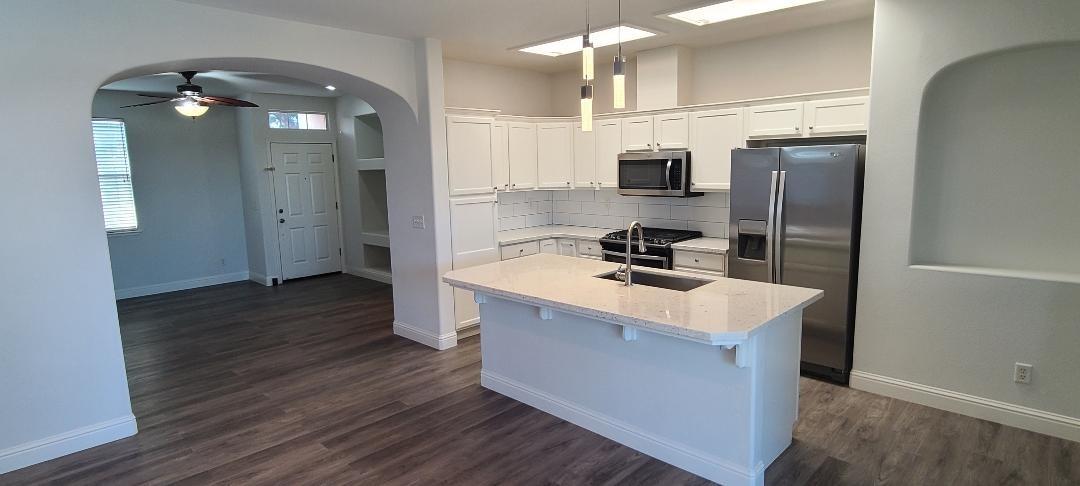 1611 North Monaco Lane Clovis, CA 93619 - Photo 2 of 16 a kitchen with a sink stainless steel appliances and cabinets