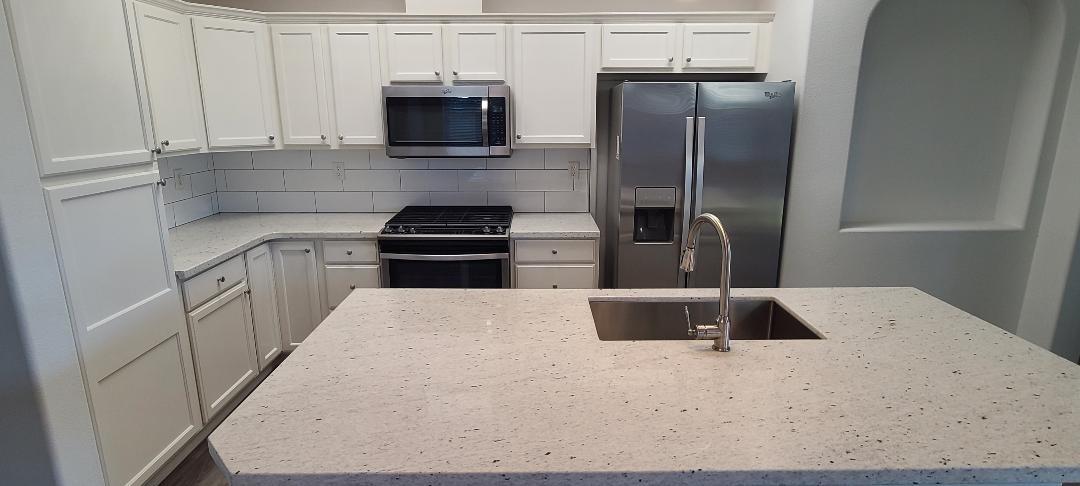 1611 North Monaco Lane Clovis, CA 93619 - Photo 3 of 16 a kitchen with a refrigerator and a sink