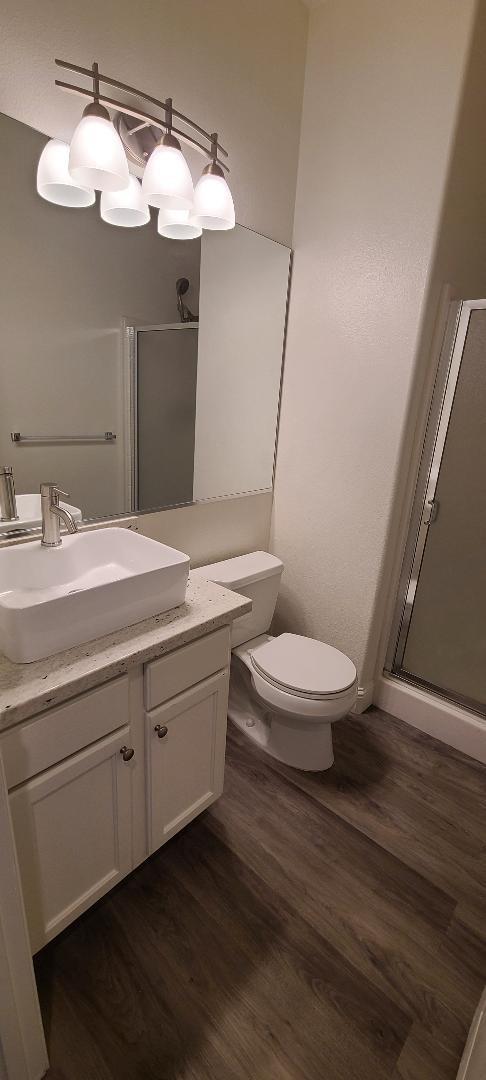1611 North Monaco Lane Clovis, CA 93619 - Photo 10 of 16 a bathroom with a granite countertop toilet sink and mirror