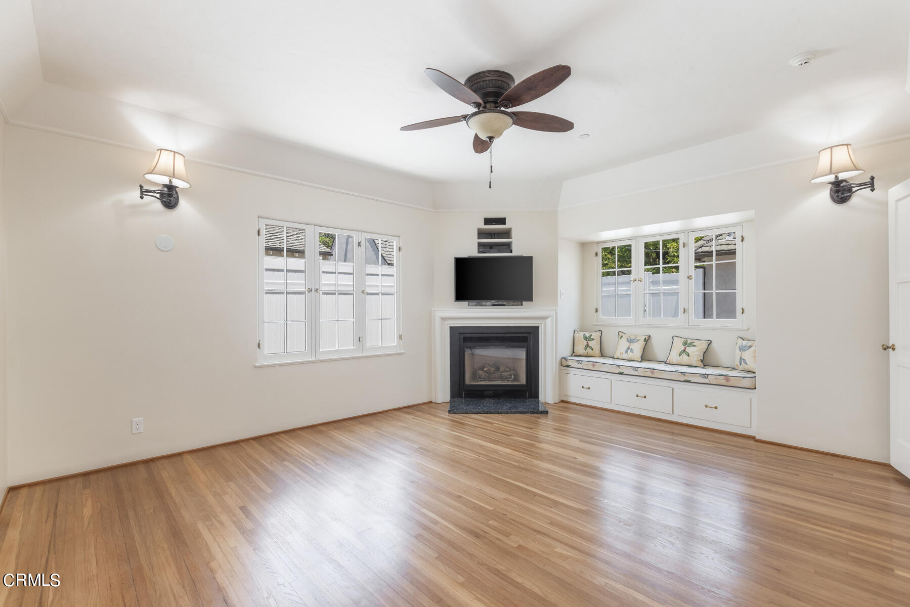 369 West Kenneth Road Glendale, CA 91202 - Photo 29 of 45 a view of a livingroom with a flat screen tv wooden floor and a ceiling fan