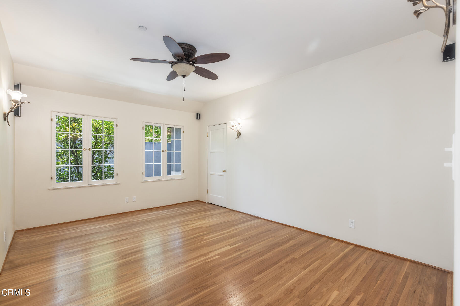 369 West Kenneth Road Glendale, CA 91202 - Photo 35 of 45 an empty room with wooden floor fan and windows