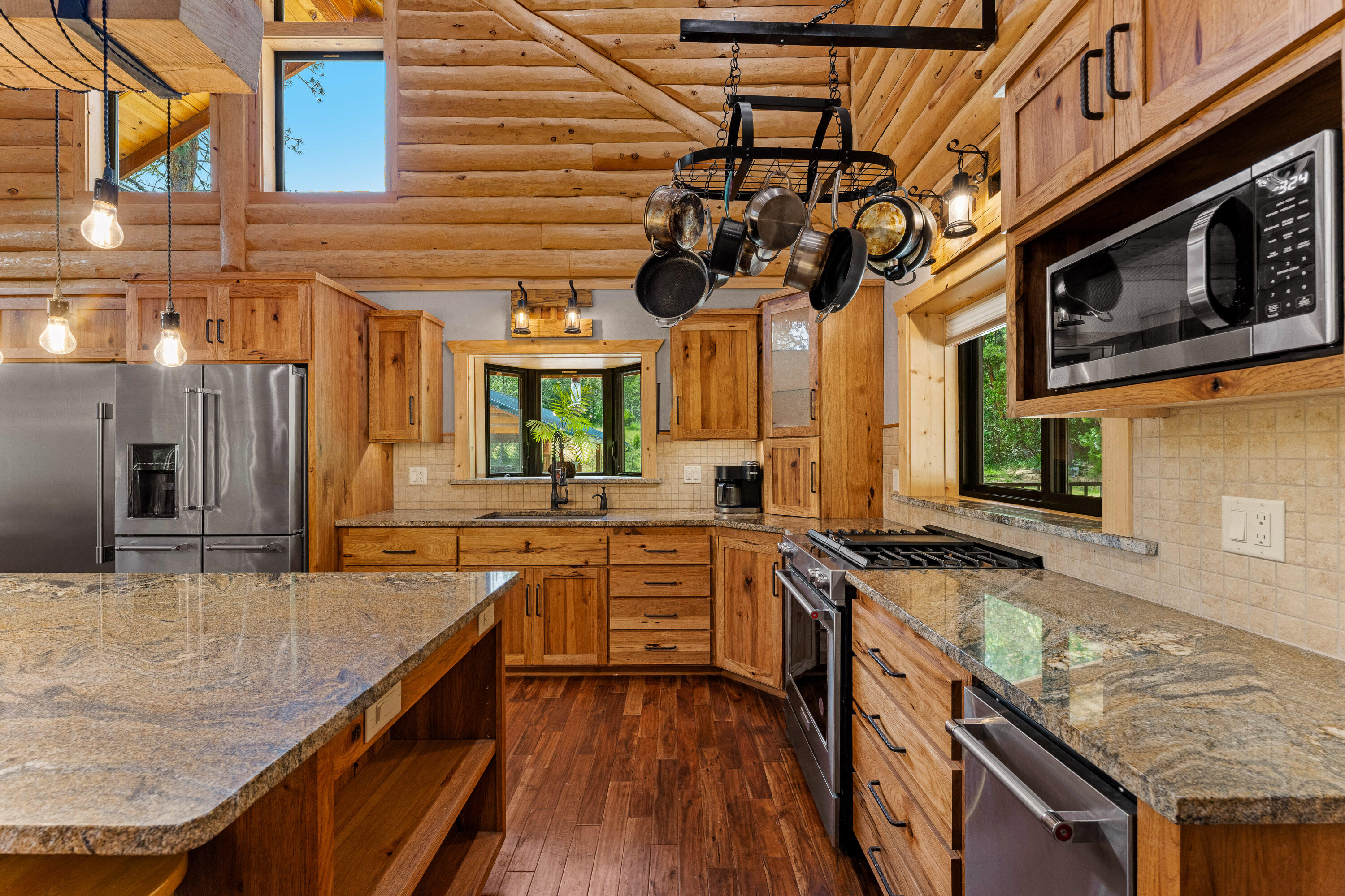 225 Eagle Ridge Road Canyonville, OR 97417 - Photo 28 of 52 a kitchen with stainless steel appliances granite countertop a sink and stove top oven