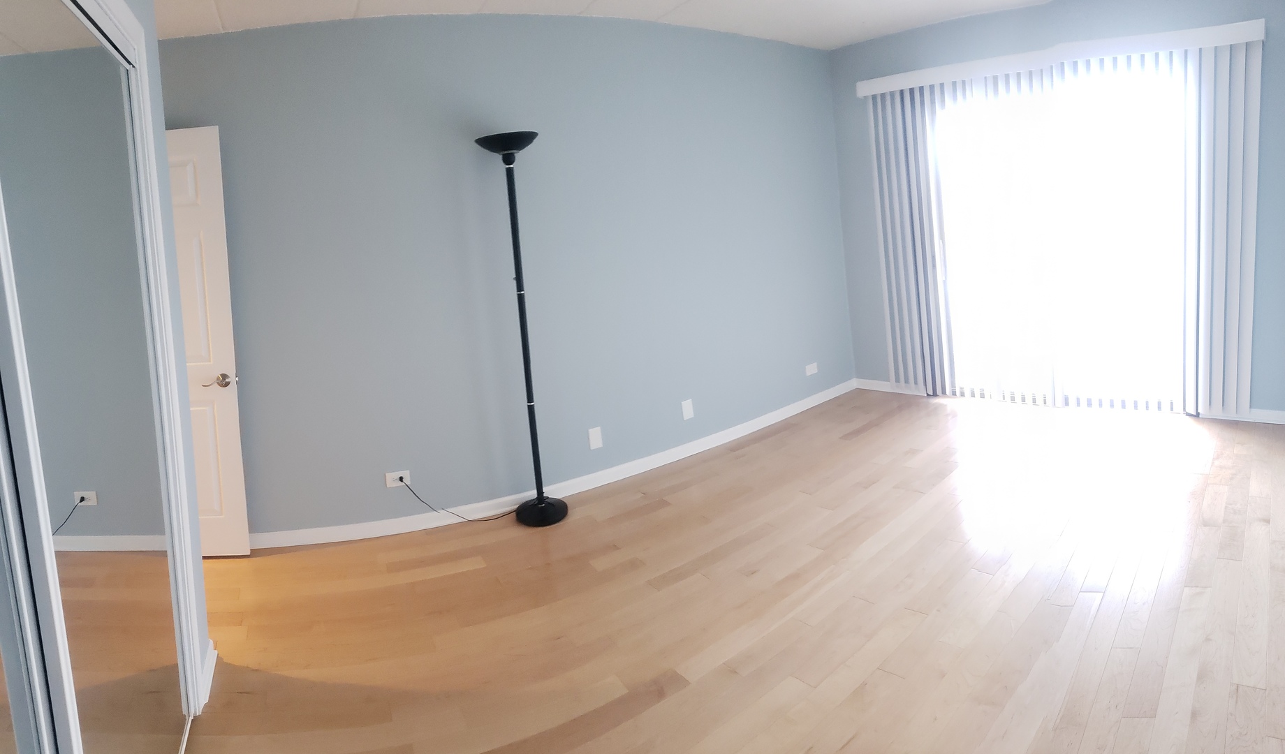 8350 West Addison Street, Unit 201 Chicago, IL 60634 - Photo 18 of 41 a view of an empty room with wooden floor and a window