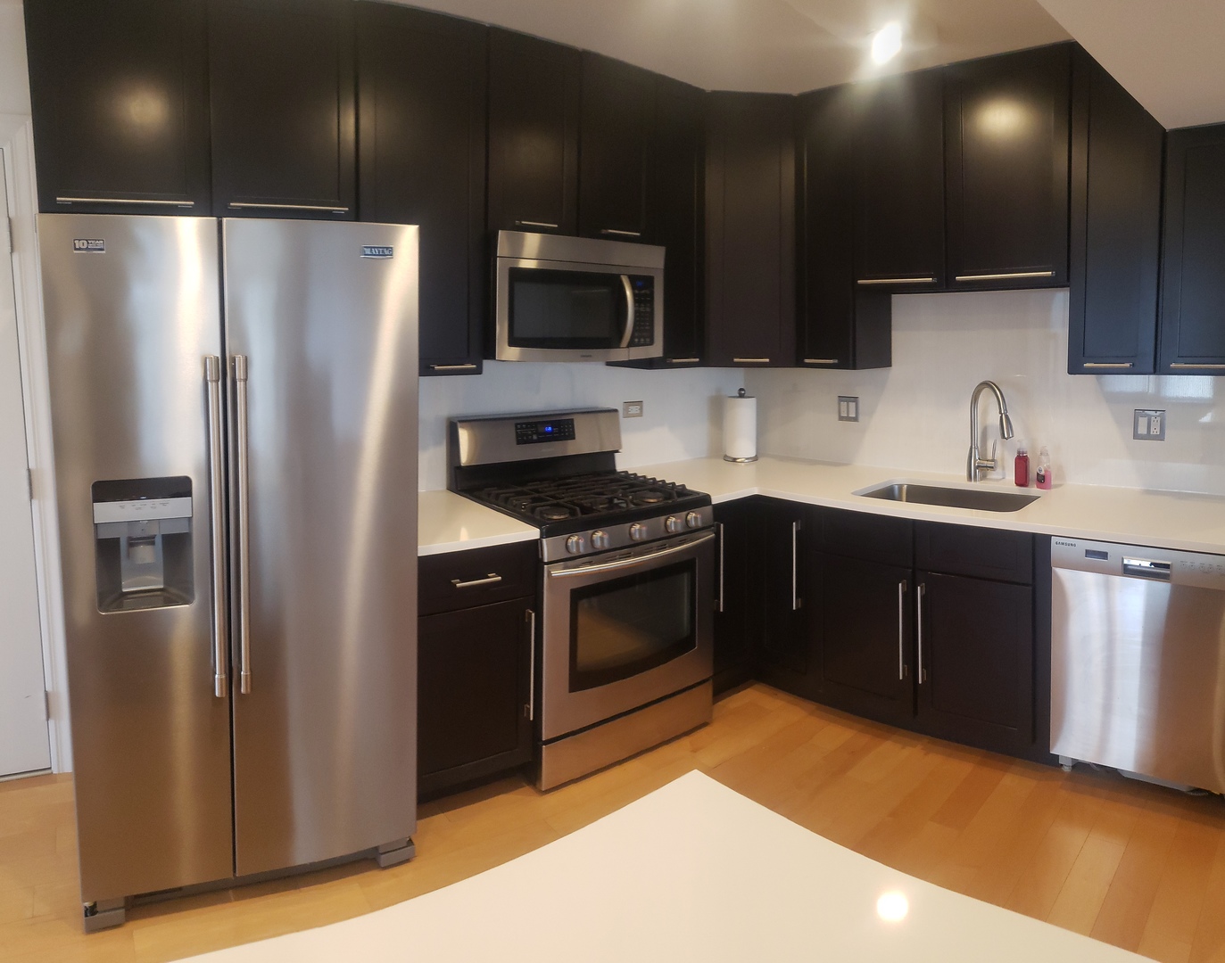 8350 West Addison Street, Unit 201 Chicago, IL 60634 - Photo 6 of 41 a kitchen with stainless steel appliances a sink stove and refrigerator