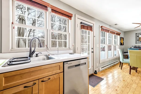 a view of a kitchen with a sink and cabinets