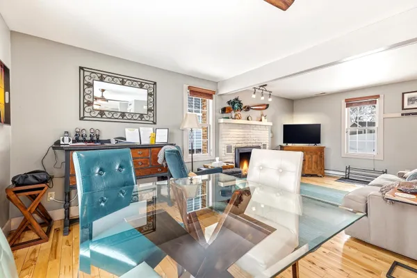 a work room with furniture a flat screen tv and a window