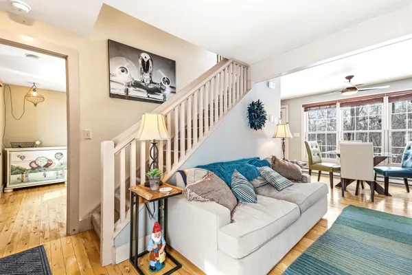 a living room with furniture and a table with wooden floor