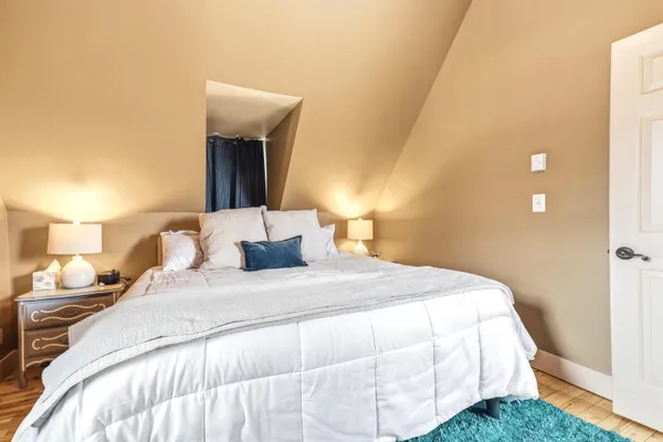 a bedroom with a bed and a mirror