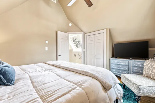 a bedroom with a bed and a flat screen tv