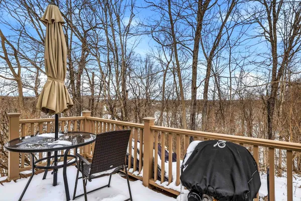 a view of a chair and table on the deck