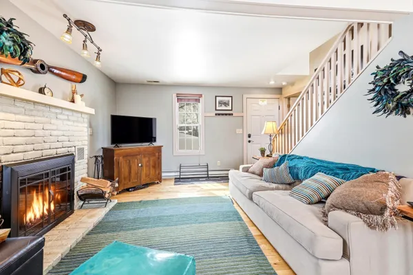 a living room with furniture flat screen tv and a fireplace