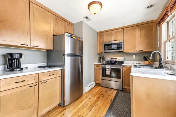 a kitchen with a refrigerator sink and microwave