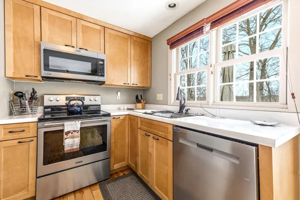 a kitchen with stainless steel appliances granite countertop a stove sink and microwave