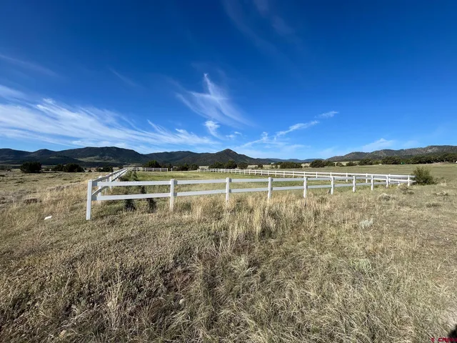 a view of a lake with outdoor seating