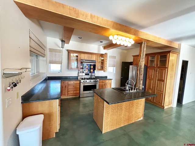 a kitchen with counter top space a sink and appliances