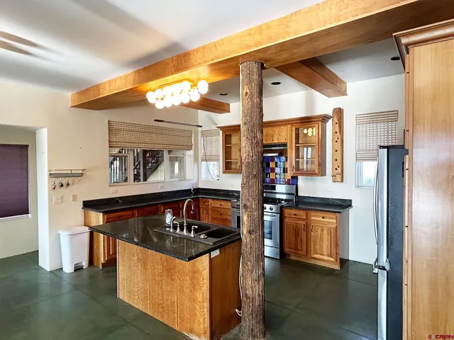 a kitchen with stainless steel appliances granite countertop a stove and a refrigerator