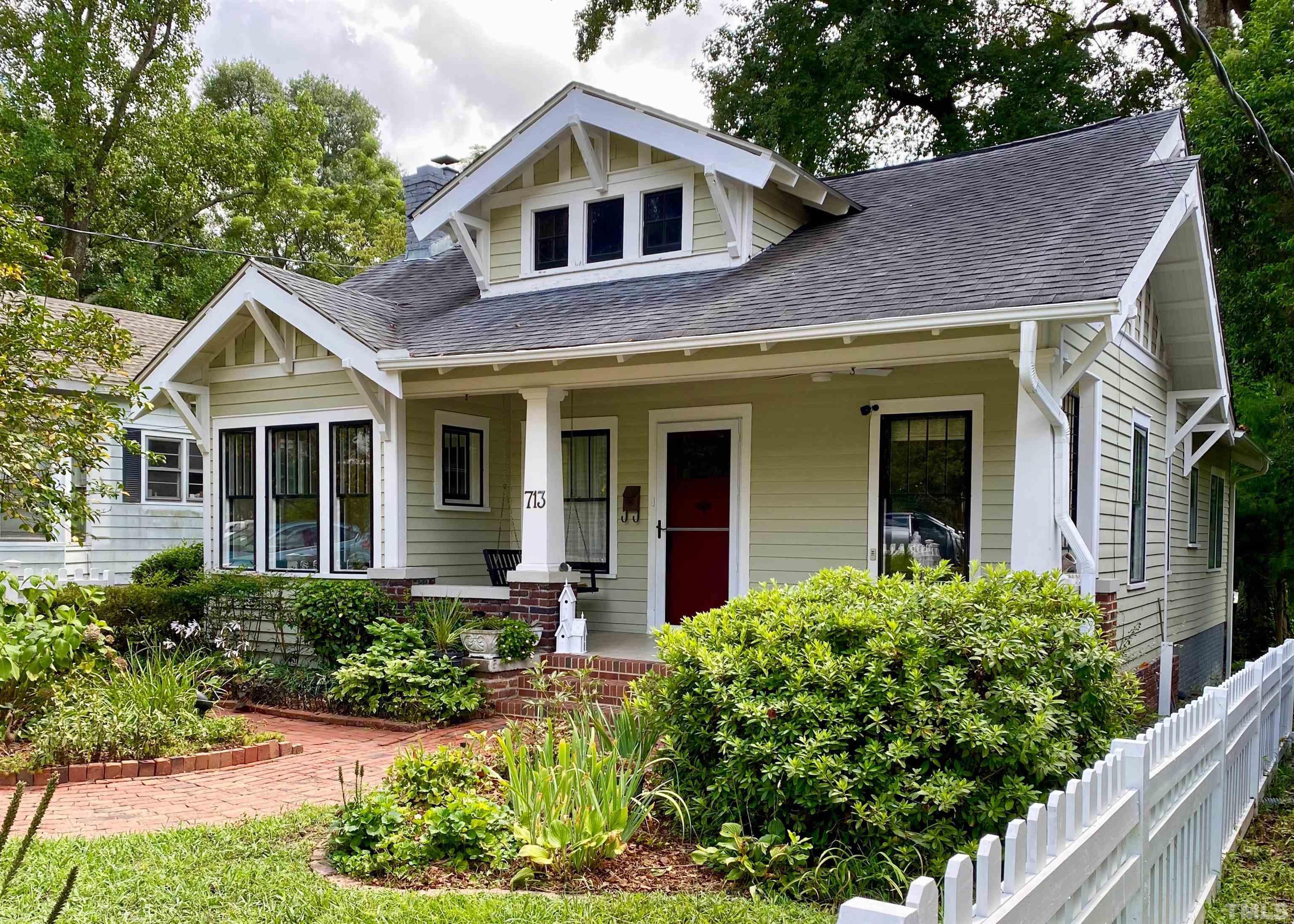 713 Dorothea Drive Raleigh, NC 27603 - Photo 1 of 23 Enjoy the beautiful lush gardens, brick walkways and white picket fenced yard from your front porch swing.