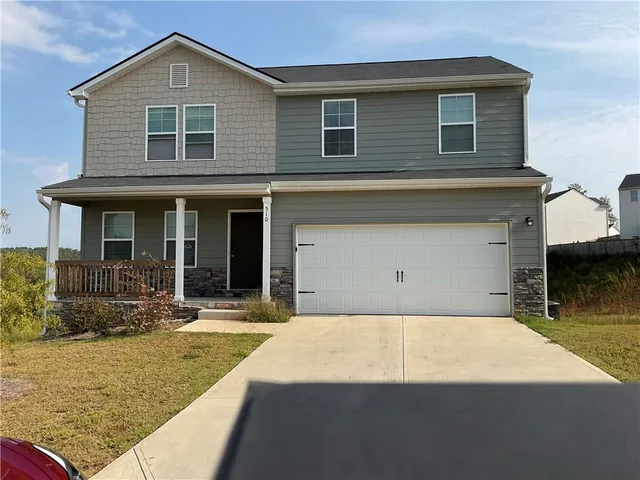 a front view of a house with yard and seating space