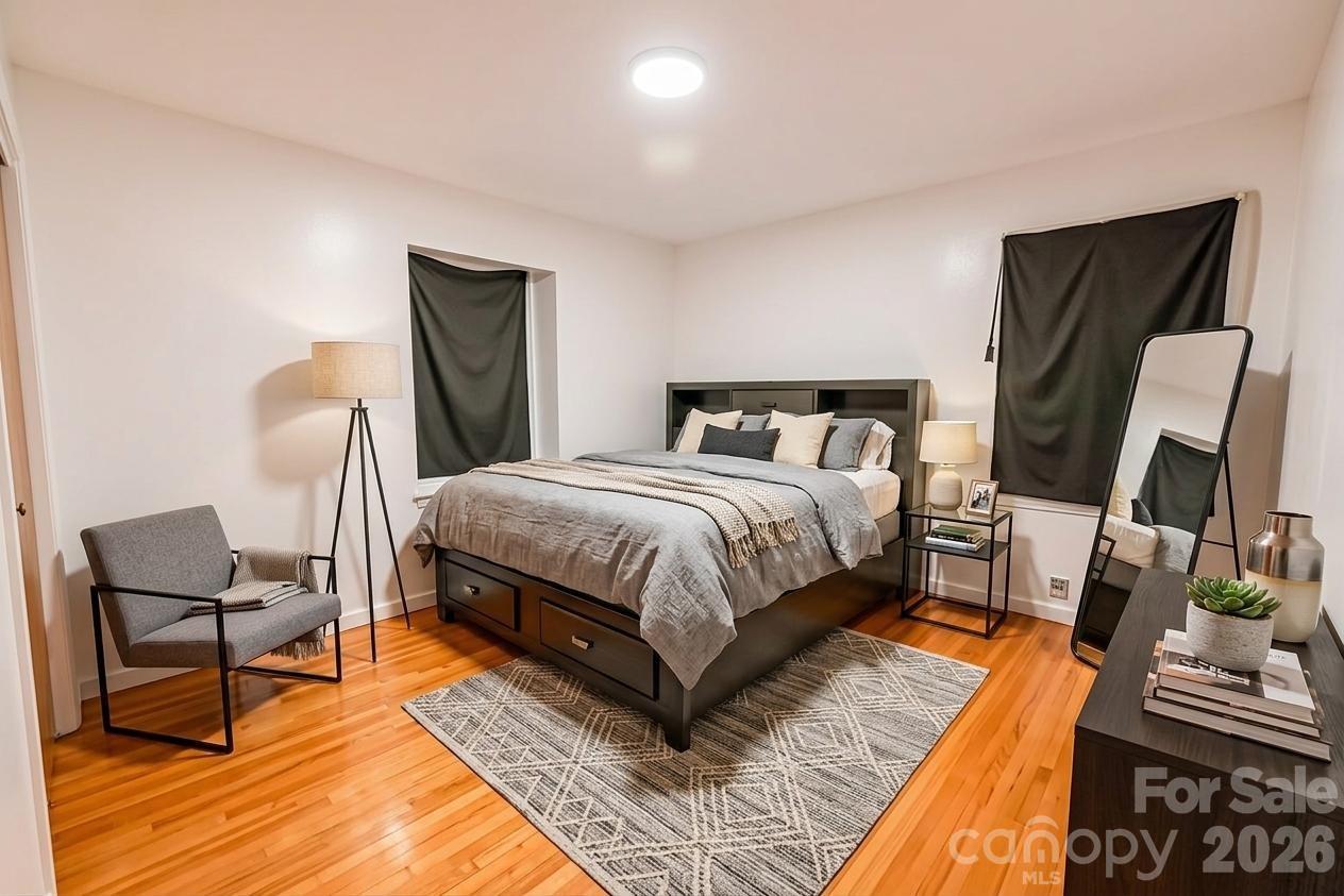 2545 Cedarwild Road Charlotte, NC 28212 - Photo 5 of 25 a bedroom with a bed and wooden floor