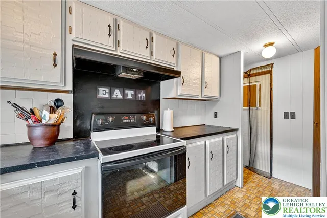 a kitchen with stainless steel appliances granite countertop a stove and a refrigerator