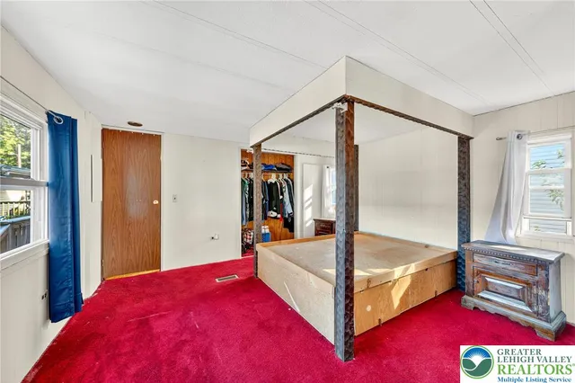 a bed room with a bed and a window