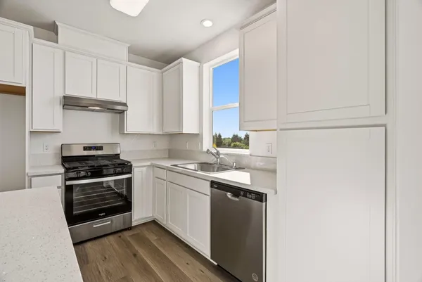 a view of kitchen and wooden floor