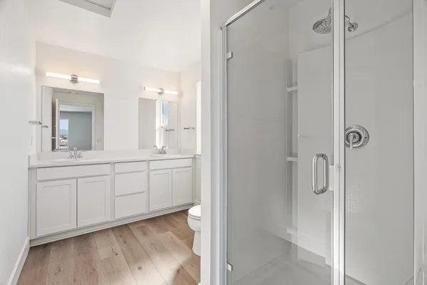a bathroom with a sink toilet vanity and tub