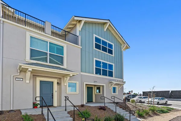a view of a hallway with wooden floor and entryway
