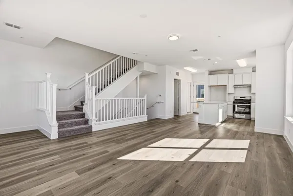 a kitchen with stainless steel appliances granite countertop a stove a sink and a refrigerator