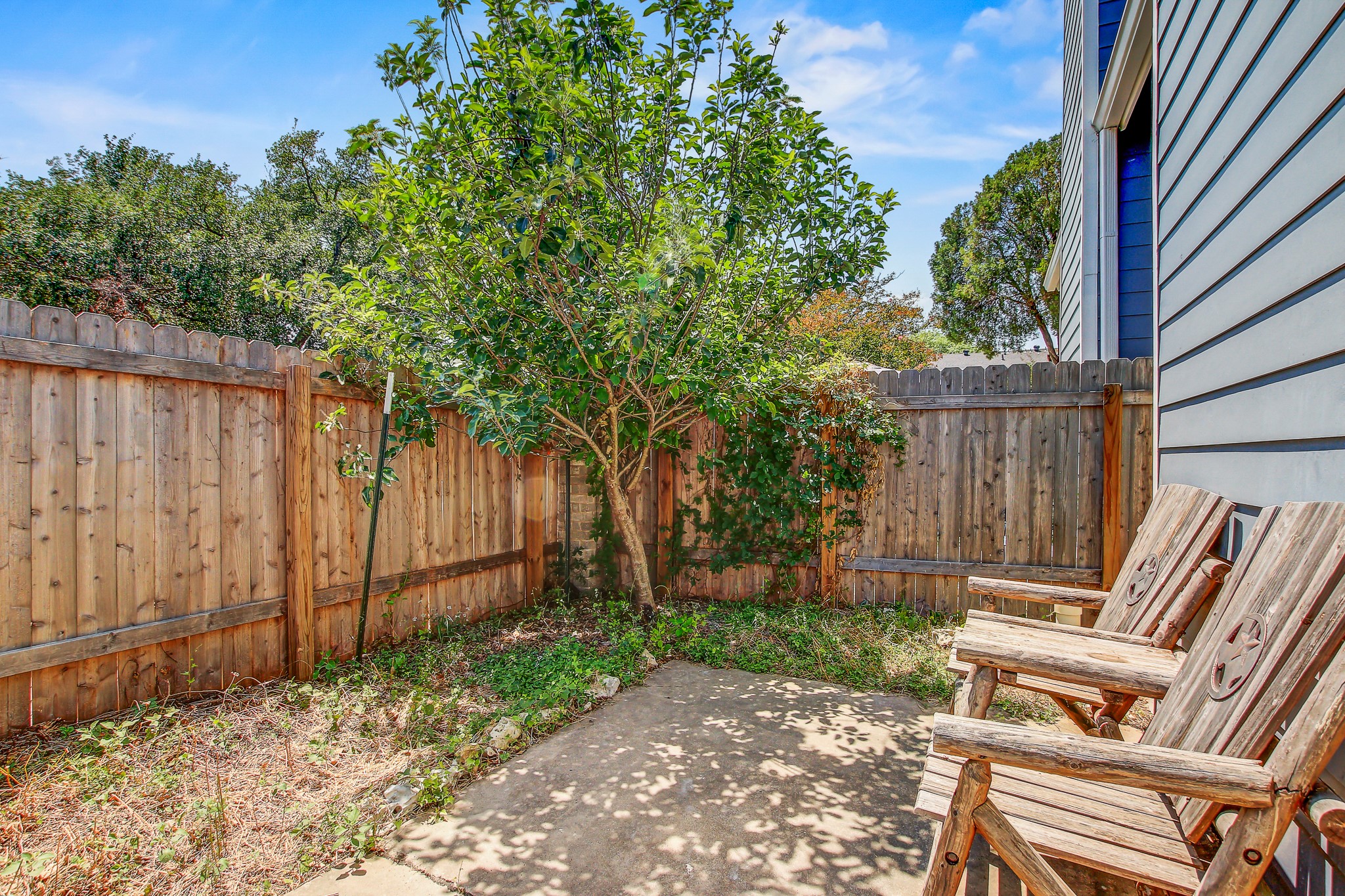 1010 West Rundberg Lane, Unit 24 Austin, TX 78758 - Photo 13 of 24 a view of wooden bench in the backyard with wooden fence