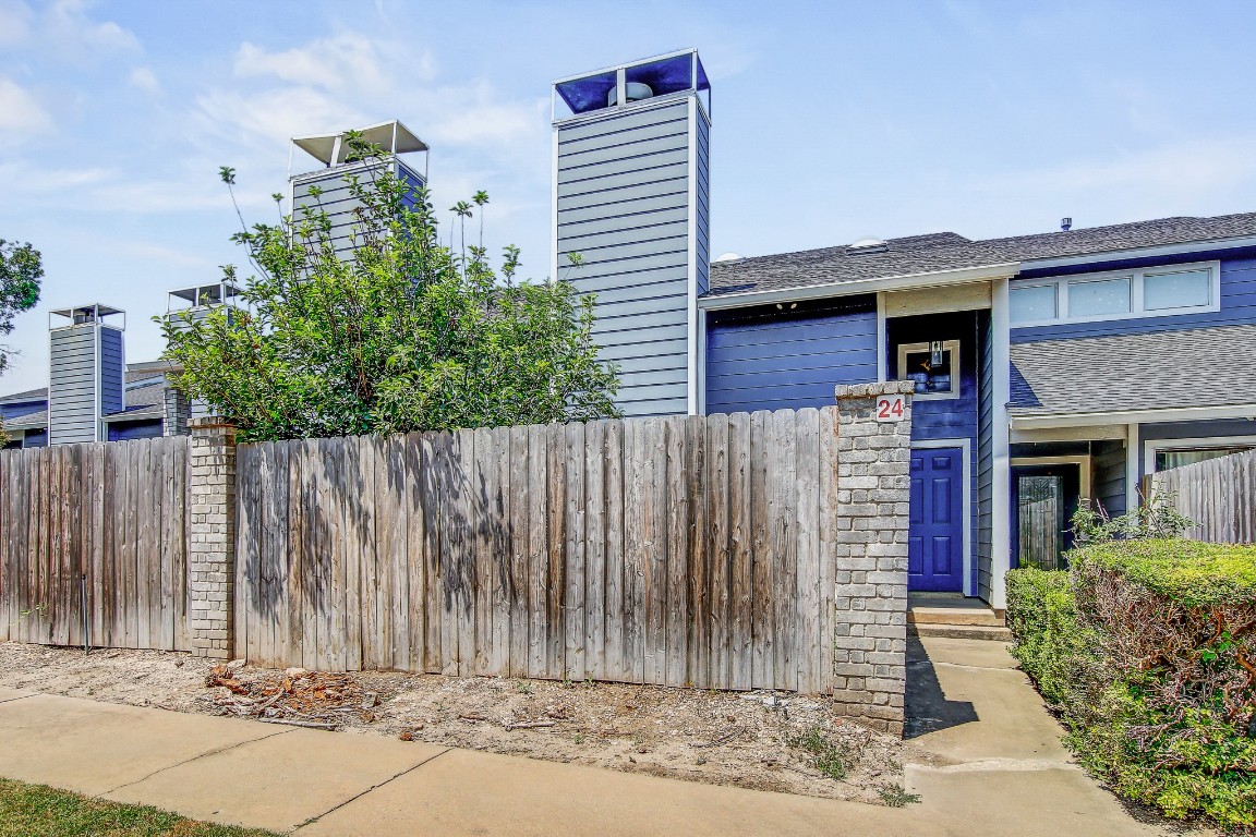 1010 West Rundberg Lane, Unit 24 Austin, TX 78758 - Photo 15 of 24 View of front of home with roof with shingles and a chimney