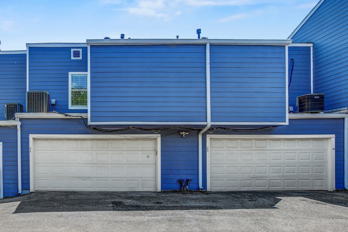 1010 West Rundberg Lane, Unit 24 Austin, TX 78758 - Photo 21 of 24 Back of property with a garage and central AC unit