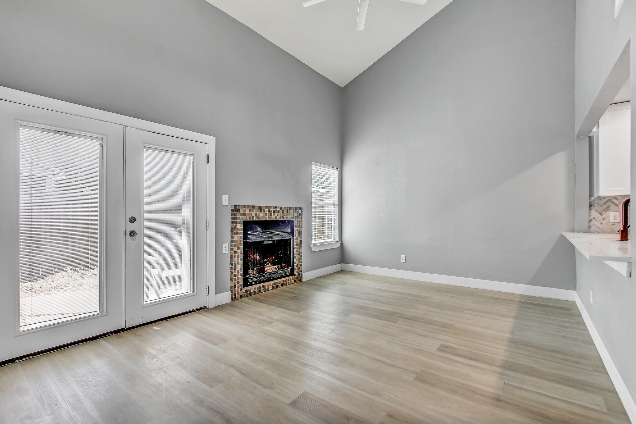 1010 West Rundberg Lane, Unit 24 Austin, TX 78758 - Photo 4 of 24 a view of an empty room with a fireplace and a window