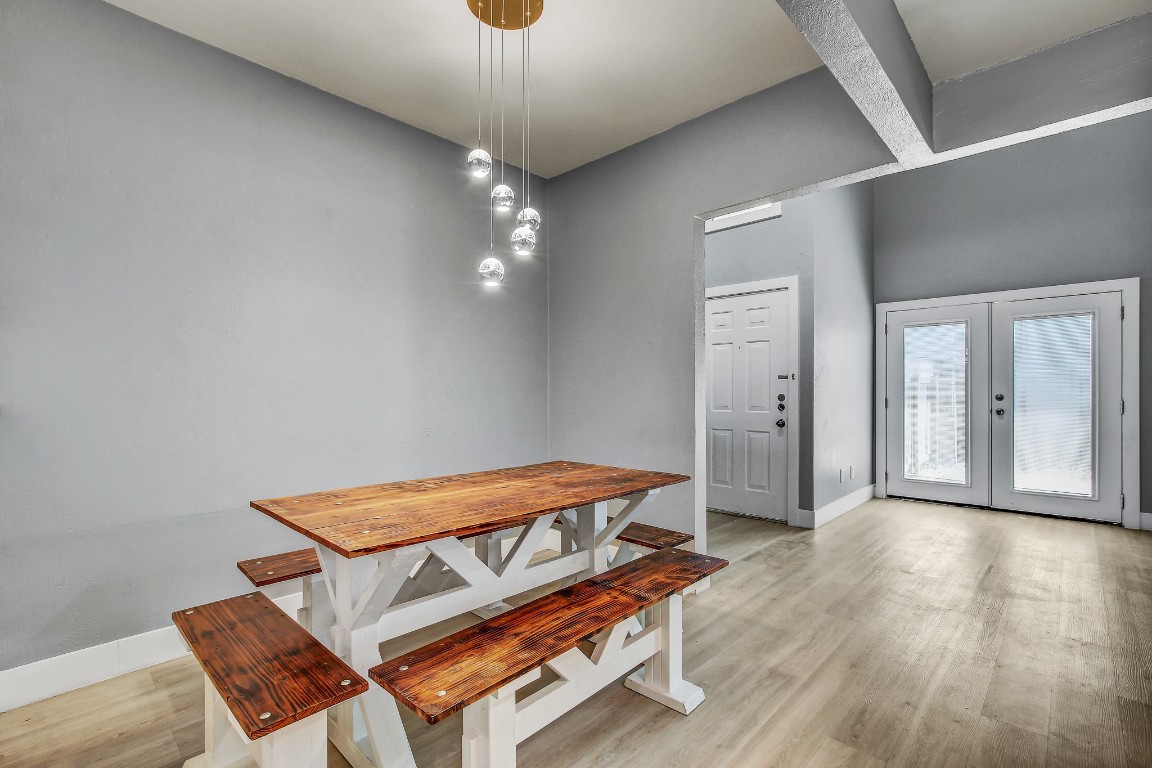 1010 West Rundberg Lane, Unit 24 Austin, TX 78758 - Photo 8 of 24 Dining room featuring light wood-type flooring, baseboards, and french doors