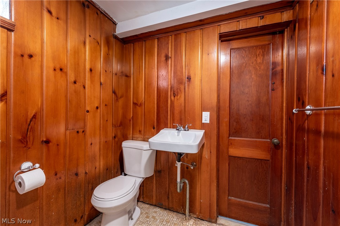 21779 Eaton Road Cleveland, OH 44126 - Photo 39 of 46 Bathroom featuring wood walls, sink, toilet, and tile floors