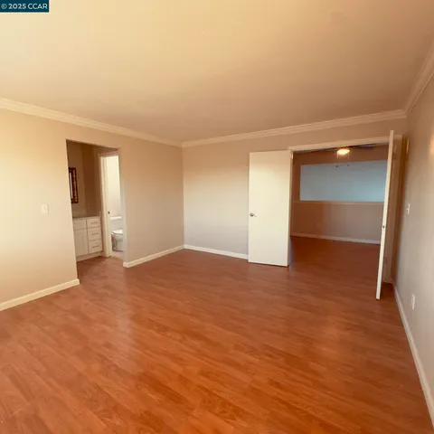 a view of an empty room and wooden floor