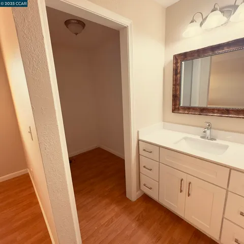 a bathroom with a sink a mirror a vanity and a shower