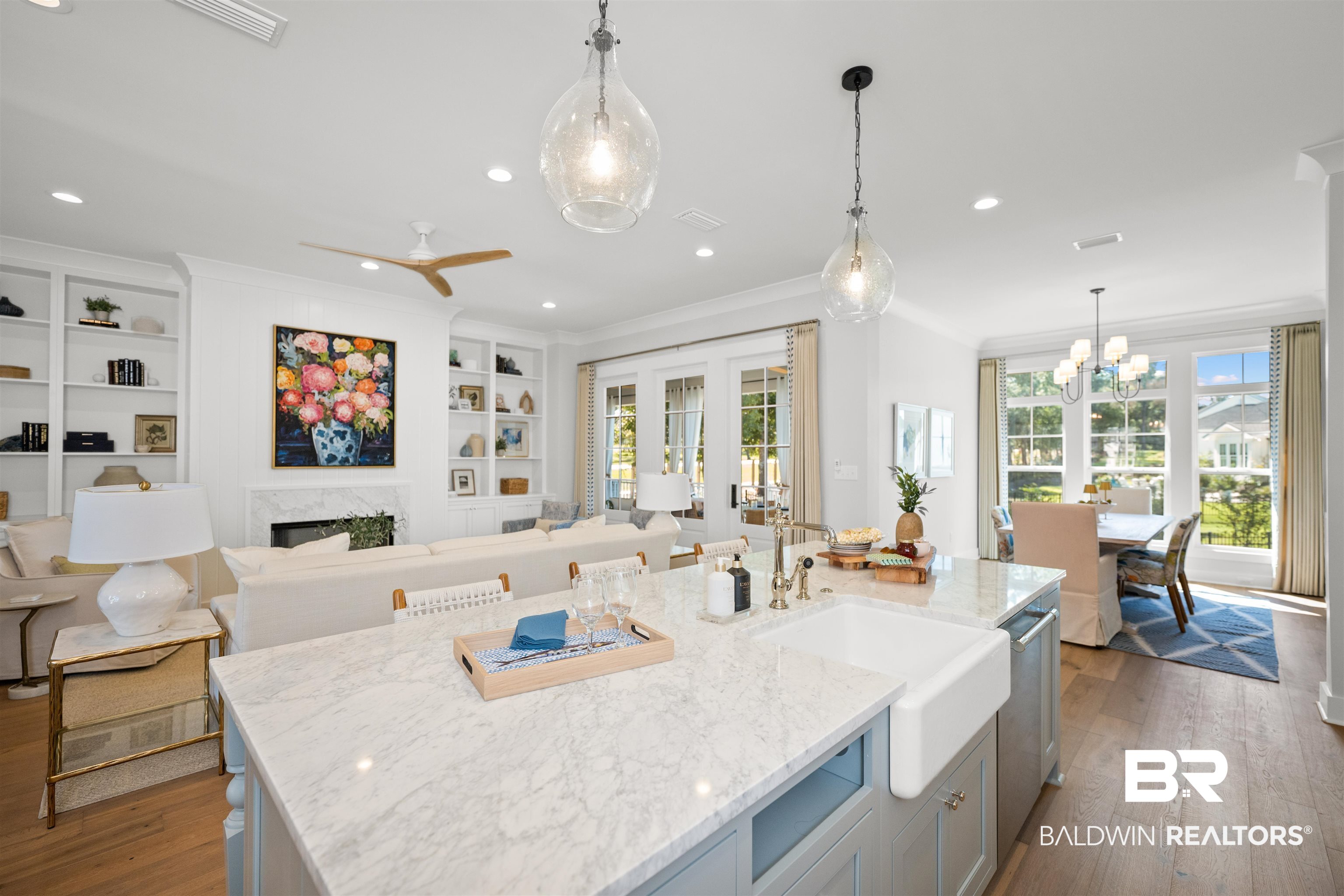 156 Hyacinth Street Fairhope, AL 36532 - Photo 15 of 61 Kitchen with decorative light fixtures, healthy amount of natural light, light stone countertops, dark wood-type flooring, and ornamental molding