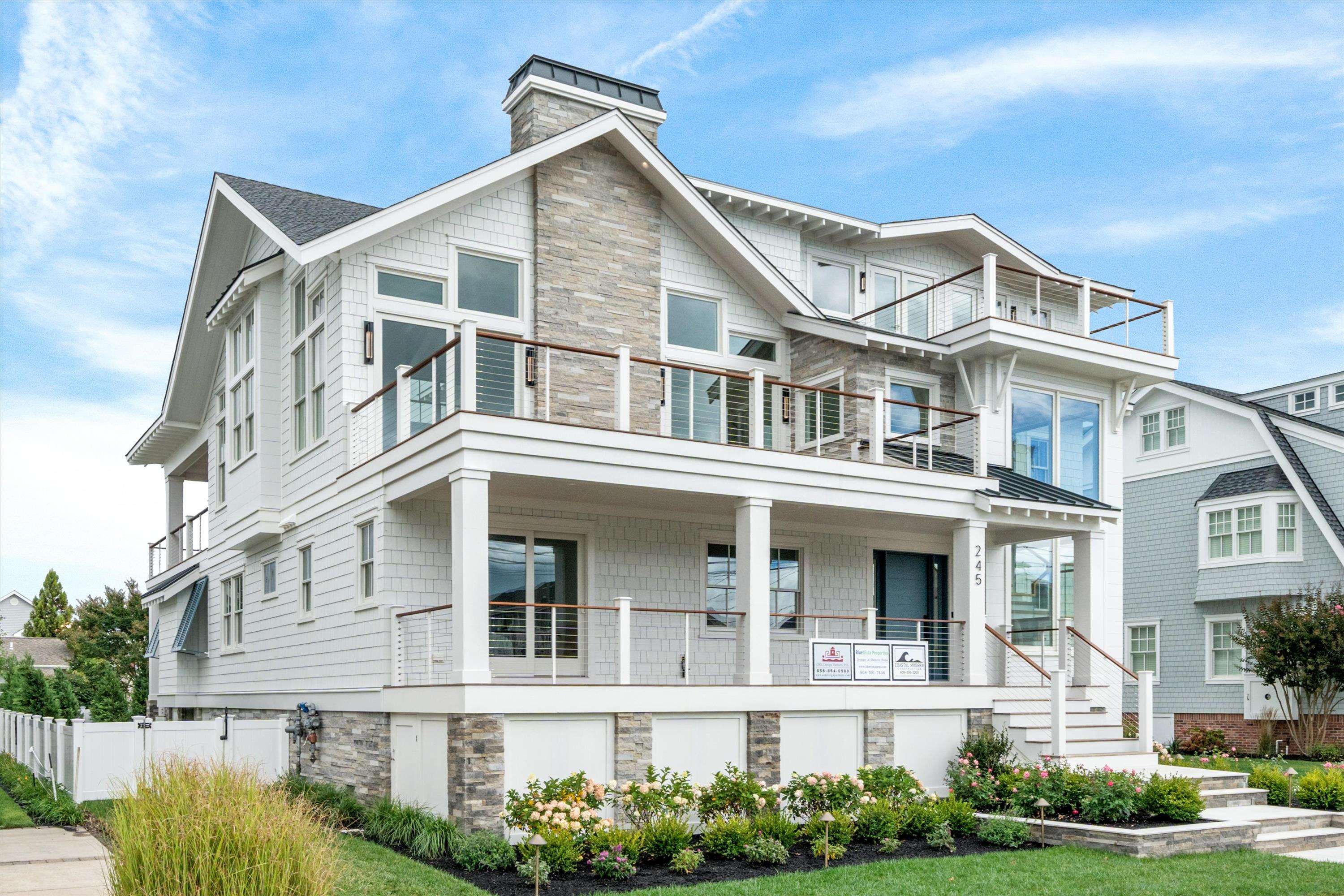 245 57th Street Avalon, NJ 08202 - Photo 1 of 50 a front view of a residential apartment building with a yard