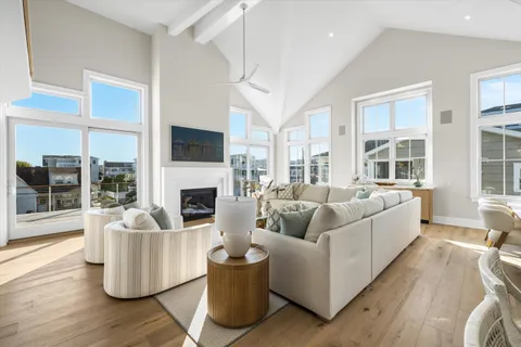 a living room with furniture a fireplace and a large window