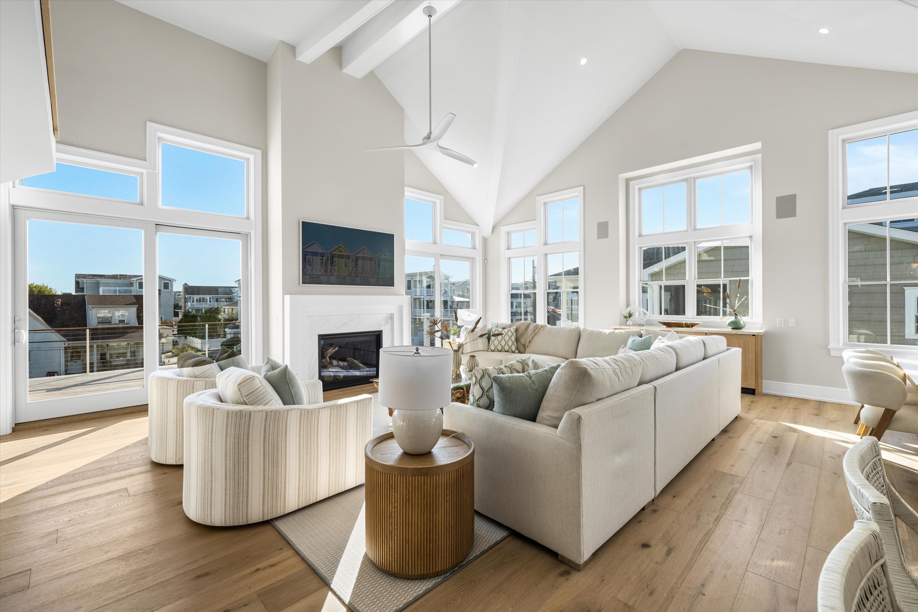 245 57th Street Avalon, NJ 08202 - Photo 13 of 50 a living room with furniture a fireplace and a large window