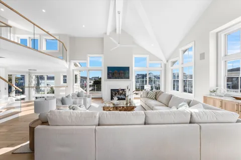 a living room with furniture fireplace and a large window