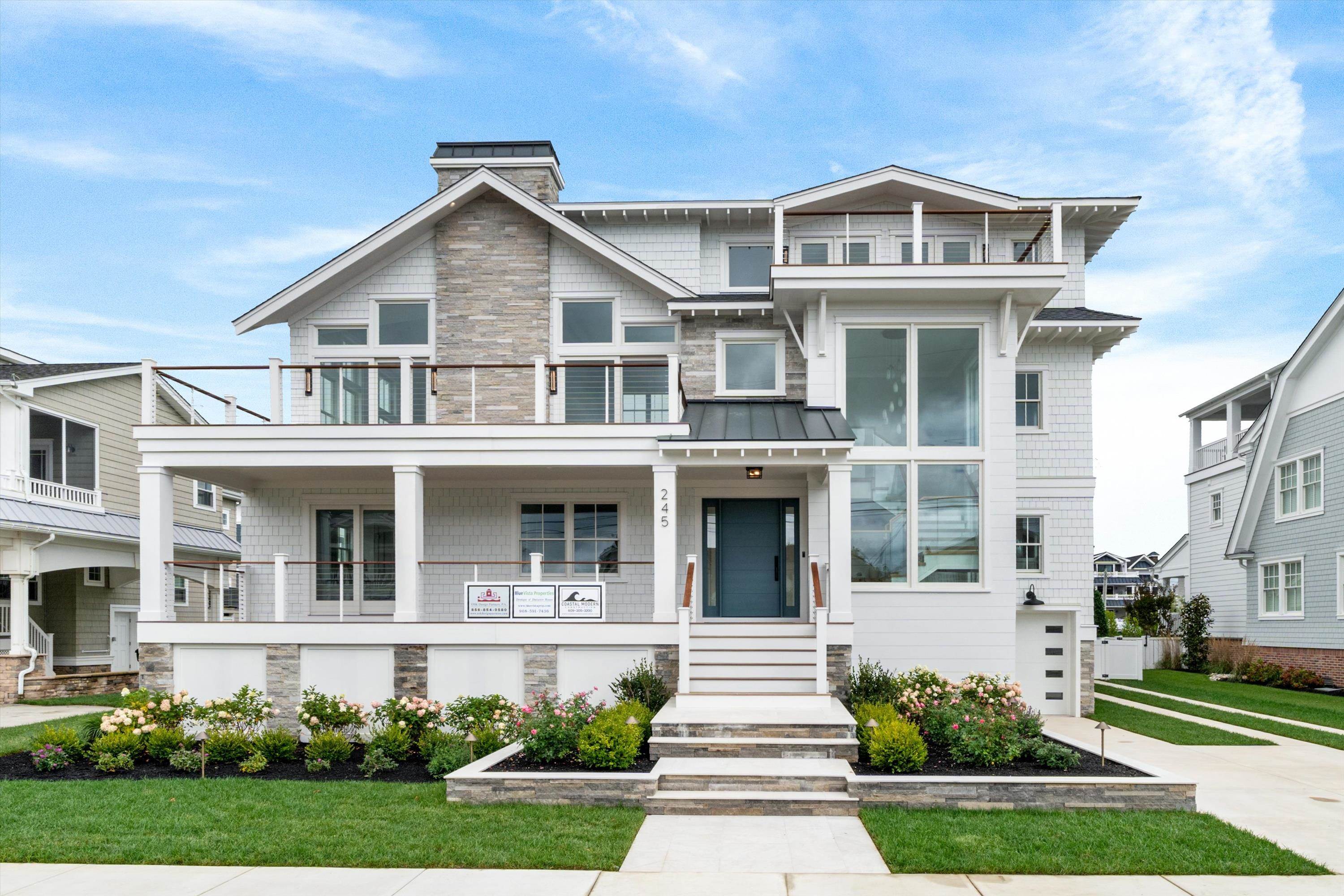 245 57th Street Avalon, NJ 08202 - Photo 2 of 50 a front view of a house with a yard