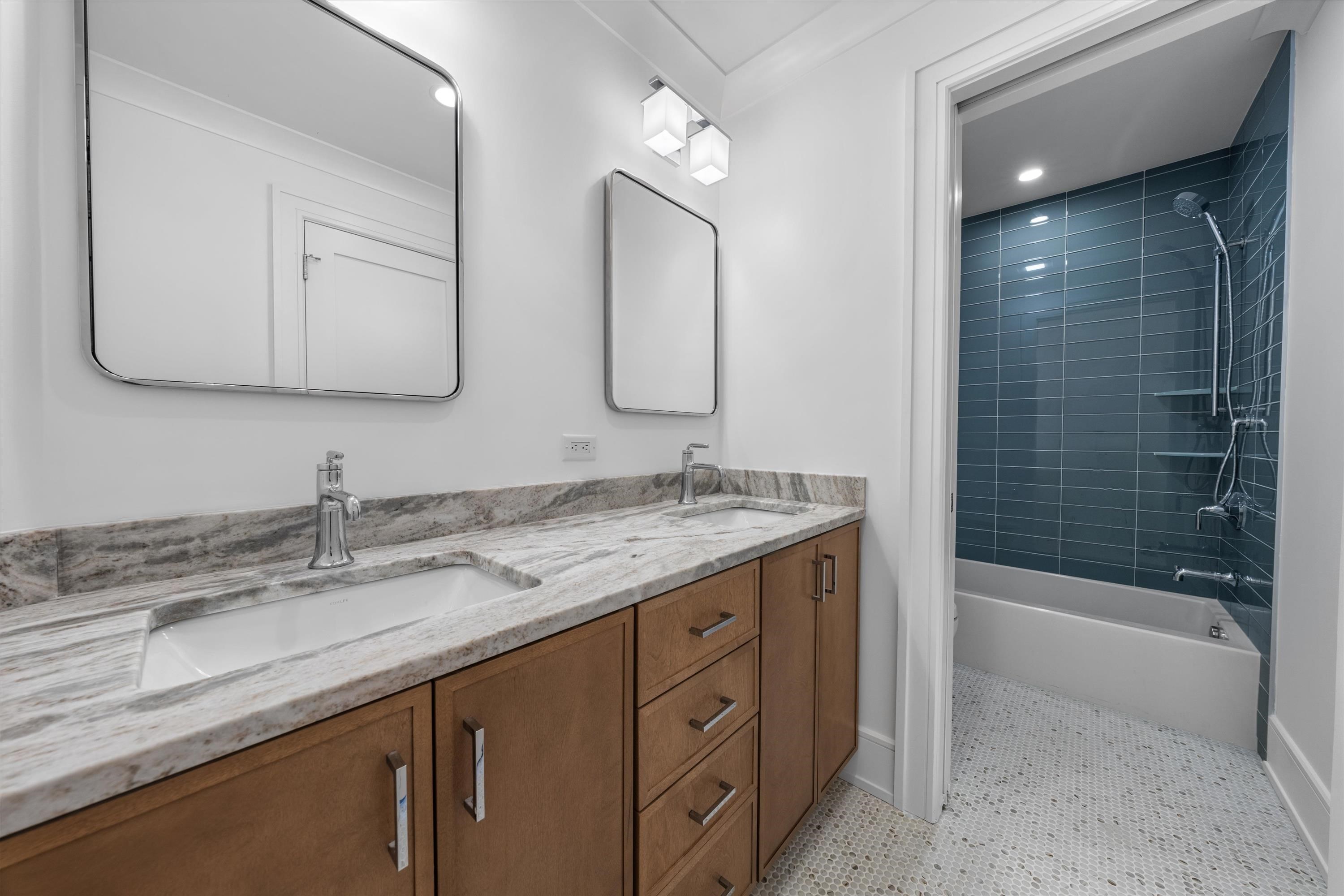 245 57th Street Avalon, NJ 08202 - Photo 28 of 50 a bathroom with a granite countertop sink mirror and bathtub