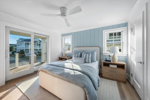 a bathroom with a granite countertop toilet a sink a mirror and shower