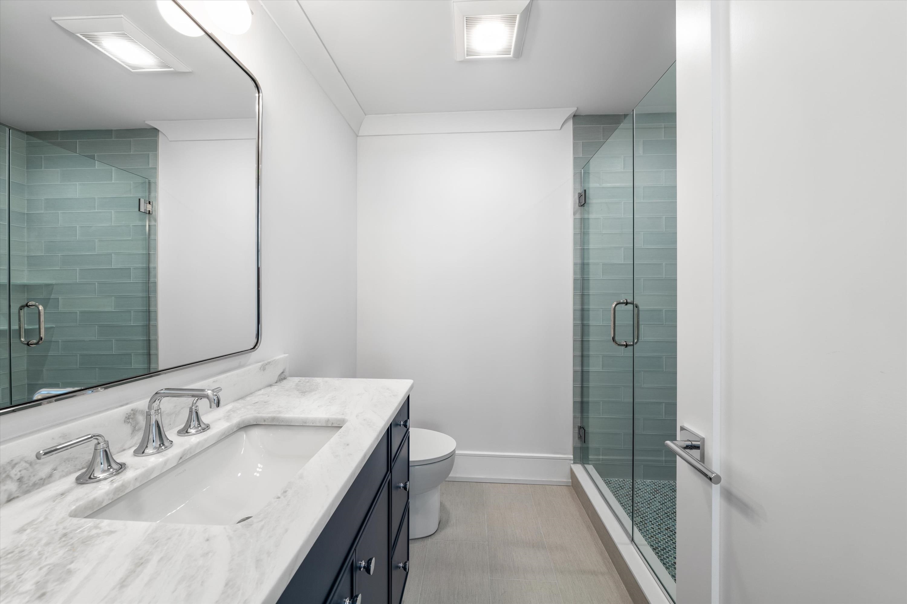 245 57th Street Avalon, NJ 08202 - Photo 32 of 50 a bathroom with a sink and a mirror