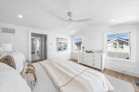 a bathroom with a granite countertop sink a toilet and shower